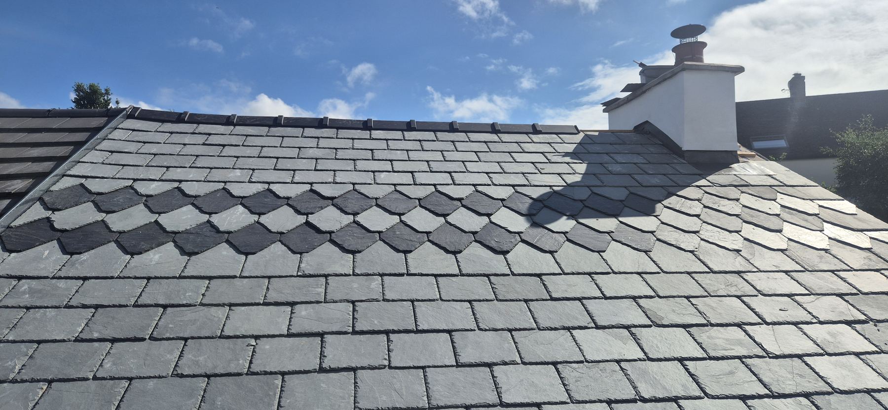 Close view of patterned slate roof work